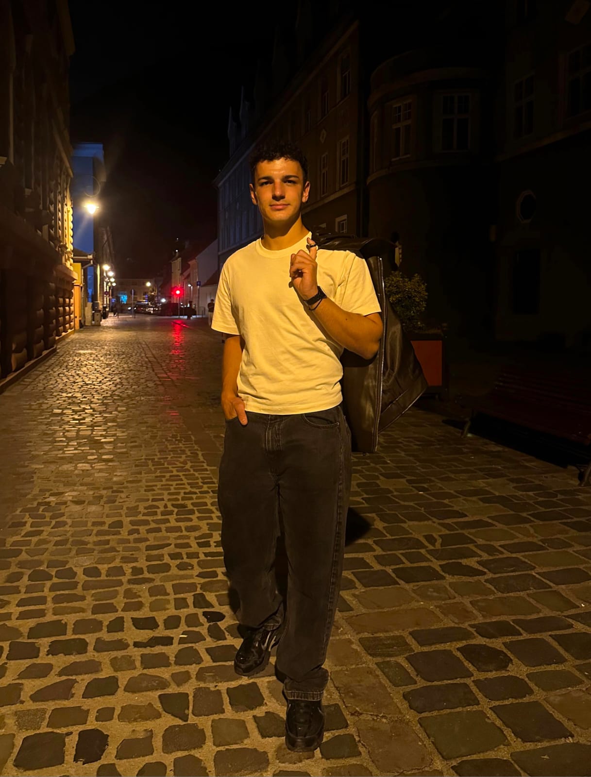 Vasi Gabriel — web designer and developer, standing on a cobblestone street at night
